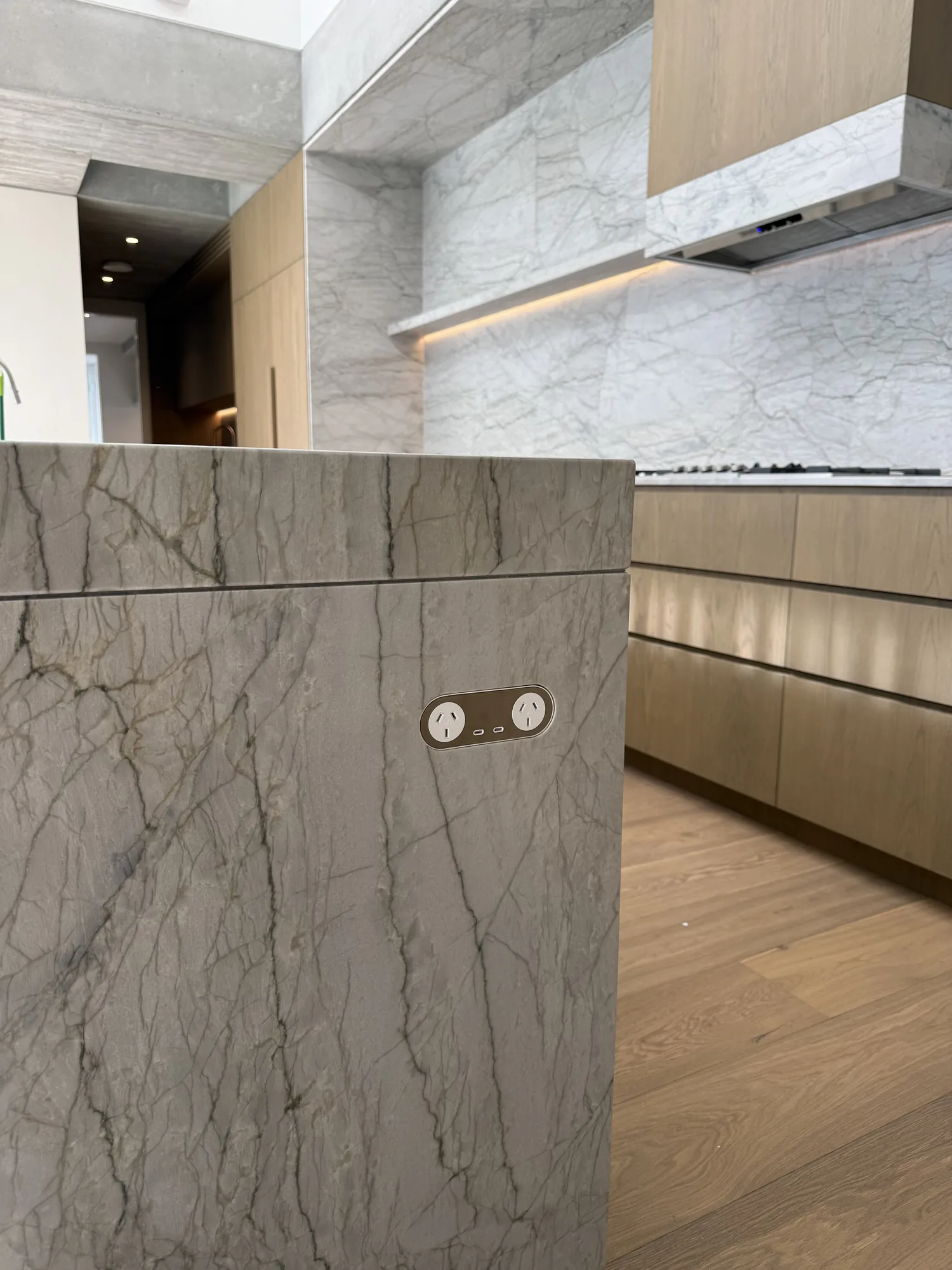 Marble island benchtop with a pop-up power point installed by Wire & Watt, Brisbane