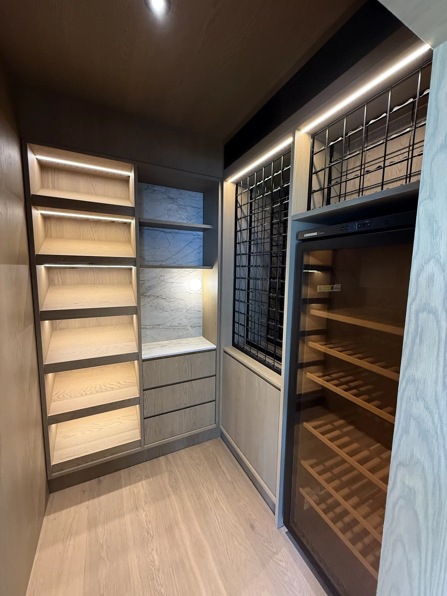 Wine cellar with LED strip lighting and climate-controlled wine fridge by Wire & Watt, Brisbane
