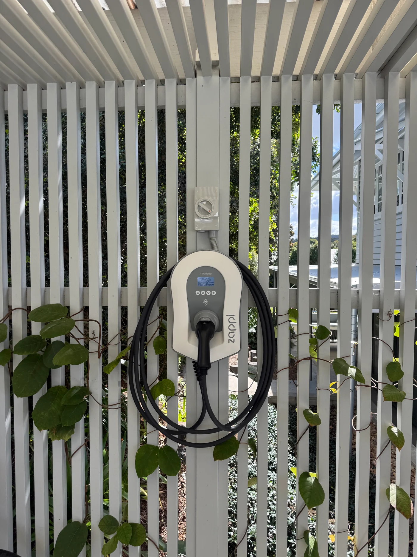 Zappi electric vehicle charger mounted on a white slatted wall in a Brisbane home